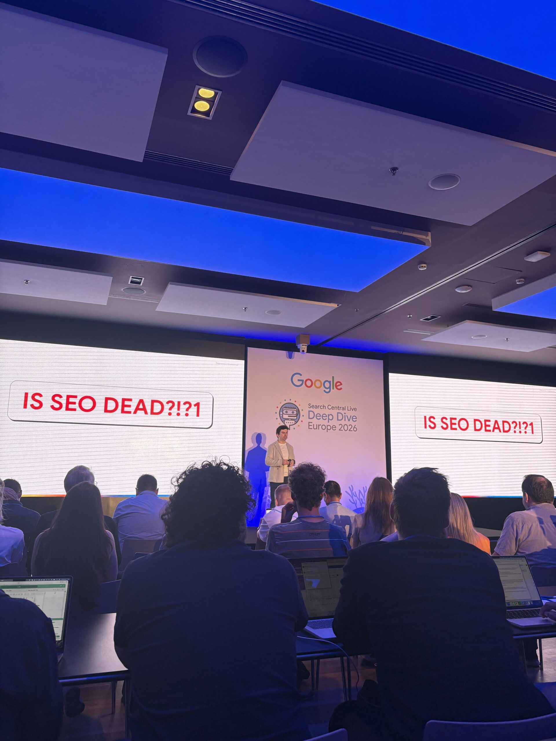 Gary Illyes from Google stood in front of a presentation screen with the text "is SEO dead?"